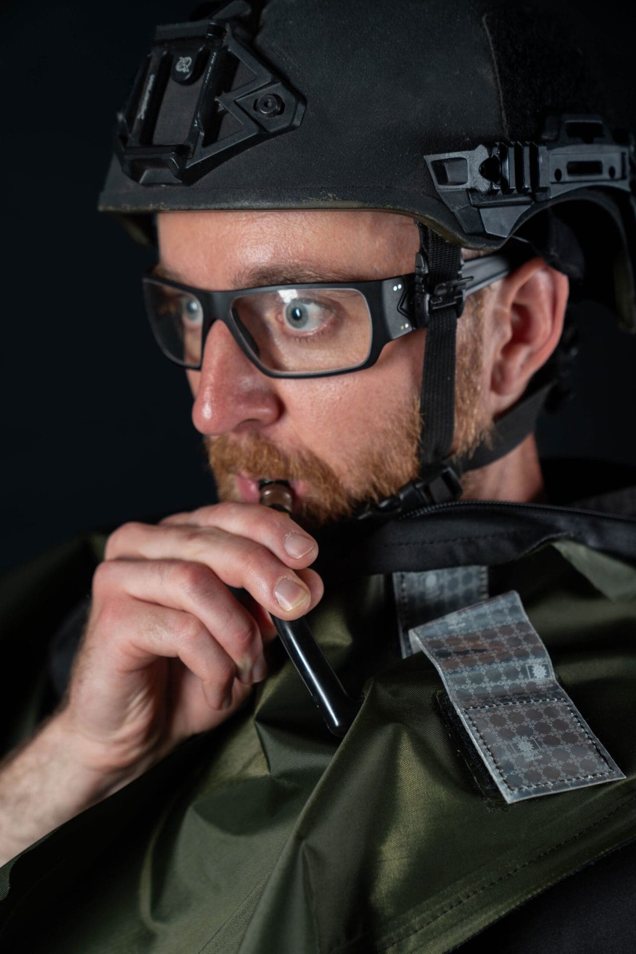 Person in military gear blowing into a tube to inflate the Galeo.